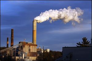 Steam billows from the coal-fired Merrimack Station in Bow, N.H. A global health commission said in a report published June 22 that substituting cleaner energy for coal will give Earth a better chance at avoiding dangerous climate change.