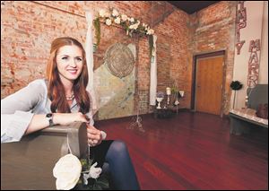 Jessica Kozak in her new business, Simply Married, in downtown Toledo. The business, kitty-corner to the Lucas County Courthouse, offers an alternative site for a wedding.