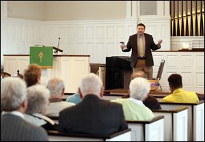 Pastor Clint Tolbert gives the welcome during a service at the First Presbyterian Church of Maumee.