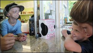 Kaylee Halko, 12, who has progeria, takes an ice cream order from Brady Ramlow, 6. They were at a fund-raiser Wednesday at Freeze Daddy’s in Monclova Township.