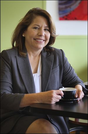 Toledo city councilman Sandy Spang sits inside Plate 21, the coffee shop she owns in South Toledo.  She is a candidate for mayor of Toledo. Mrs. Spang is hoping to leverage her newness into support from those who are tired of seeing the same people in office.
