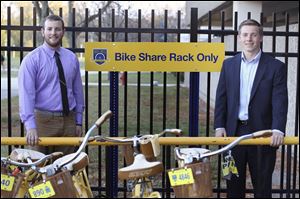 Student government President Cody Spoon, left, and Vice President Ian Michalak show one of the racks of bicycles that students can borrow.