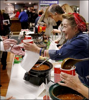 Shawn Clark serves chili during the fund-raiser event at the Conn-Weissenberger American Legion in West Toledo.