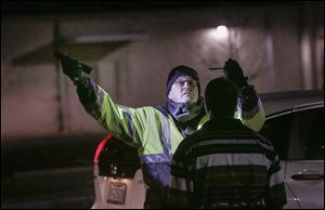 Washington Township patrol officer Eric Hart administers the horizontal gaze nystagmus test during a sobriety checkpoint over the weekend along Reynolds Road.