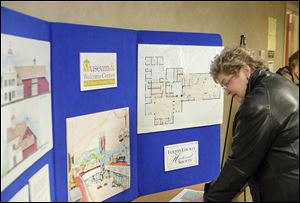 Beverly Ernst of Delta, Ohio, a trustee for the Fulton County Historical Society, looks at plans for the Museum & Welcome Center of Fulton County, Ohio. The multiuse building will promote local history in a much larger space than the county’s current museum.