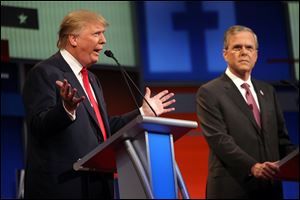 Republican presidential candidates Donald Trump, left, and Jeb Bush speak during a debate at the Quicken Loans Arena in August. The party will return to the Cleveland venue in Cleveland for its convention in six months.
