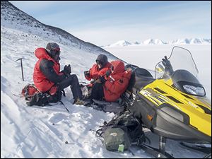 Mountaineering guide Tim Burton, graduate adviser Kurt Panter, and graduate student Jenna Reindel take a lunch break on the slope of Sheridan Bluff in Antarctica.