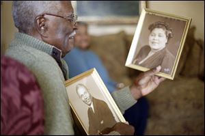 Clyde Hogan holds a picture of his father, William Hogan and his mother, Mildred Hogan. The Hogans moved to Toledo from Florida when Clyde was about 5 years old. The number of African-Americans in Toledo reached 40,000 by 1960.