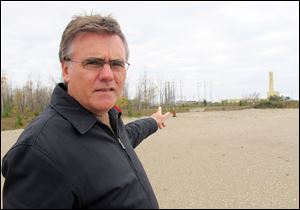 In this Nov. 1, 2013 photo, Neal Kelly, spokesman for Ontario Power Generation, stands in the area of the Bruce Power nuclear power complex in Kincardine, Ontario, where OPG proposes to drill a chamber to permanently store low- and intermediate-level radioactive waste more than 2,000 feet below the earths surface near Lake Huron. 