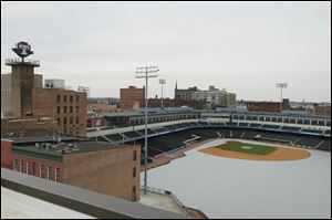 A view of the ballpark from 28 St. Clair Street. The rooftop deck is called High Five. Hensville, an area with rehabilitated buildings with retail, office and dining spaces, will open Thursday, St. Patrick’s Day.