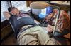 Tattoo artist inking over others’ pain