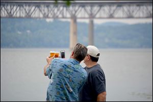 Two men compare beers at one of the America On Tap festivals.