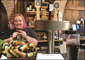 When Black Cloister Brewing Company manager Mandy Cufr isn’t waiting on customers, she knits behind the bar.