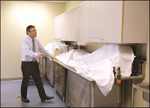 Hazzan Ivor Lichterman checks the kitchen of Congregation B’nai Israel before Passover. All of the chametz, or leavened bread, must be cleaned from a home before Pesach, and tables scrubbed and covered if they are going to be used during the holiday.