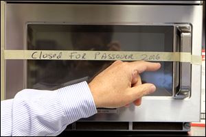 A microwave not ‘kashered,’ or made kosher, is taped up for Passover. 