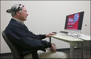 John MacWherter views a negative political advertisement for Donald Trump during a study in April in Akron. As the amount of political ads increases this election season, researchers are studying how viewers react to the messages.