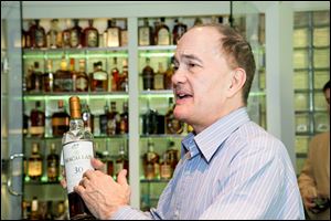 Allan Block shows his bottle of MacCallan 30, a rare and well aged Speyside whisky valued at $3,000. 