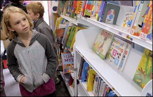 Hannah Herrling, 10, checks out the books in the Ready to Read early literary outreach van.