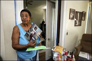 Gloria Johnson holds a photo of her great-grandchild, Dre’velle Slay, 3, at her home on Putnam Street in Toledo. Dre’velle has been diagnosed with lead poisoning.
