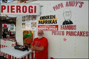 Papa Andy's Famous Potato Pancake owner, Andy Emrisko, poses with his food stand. Emrisko, a Cleveland native, has been serving potato pancakes at the Lagrange Street Polish Festival for 19 years.