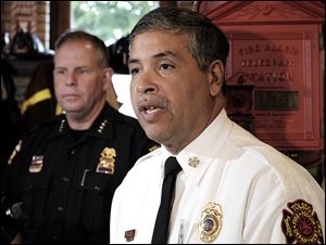 Toledo Police Chief George Kral, left,  and Fire Chief Luis Santiago discuss the city’s ballot issue in September. If it fails, hundreds of police officers and firefighters could lose their jobs.