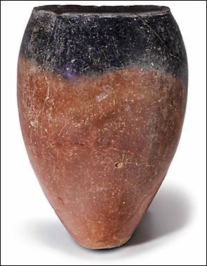 Among the items being sold on the online auction is an Egyptian black-topped pottery jar. A prominent archaeologist has criticized the sale as a mistake. 