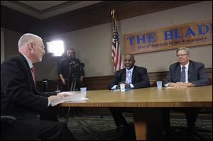 Blade Editorial Page Editor Keith Burris, left, introduces county commissioner candidates Mike Bell, a Republican, center,  and Pete Gerken, a Democrat, during a televised debate at The Blade. The event was Oct. 20. 