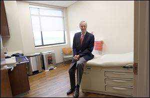 Dr. Rex Mowat sits in a consultation room during a tour of the Mercy Health Perrysburg Cancer Center on November 2, 2016.