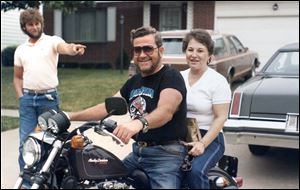 This 1984 photo of Martin Fewlas provided by the family shows him on a Harley-Davidson motorcycle with wife Donna Fewlas on back.  The man at left is James McLaughlin, nephew of Martin Fewlas.