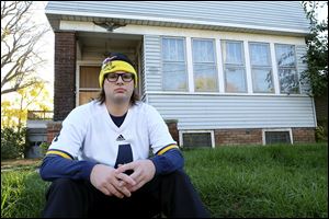 Jimmy McLaughlin sits in front of his late great uncle’s duplex at 2557 Broadway in Toledo. Three people face trial for allegedly faking a will, giving them the $2.2 million that would have gone to Mr. McLaughlin.