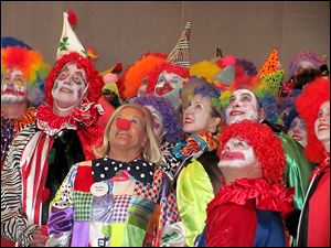 Members of the Toledo Clown Corps check out the floats in the Blade Holiday Parade last year.