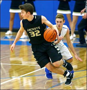 Perrysburg's Zach Pohlman spins to juke Anthony Wayne's Josh Boyer during a game last season. Pohlman is one of the Yellow Jackets' leaders in 2017-18.