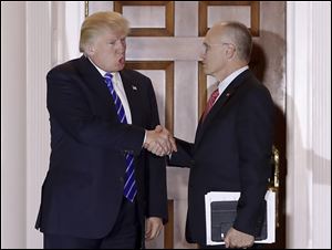 President-elect Donald Trump and Andy Puzder, chief executive of CKE Restaurants and his choice for labor secretary, shake hands as Puzder leaves Trump National Golf Club in November.