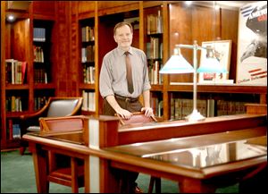 Edward Hill, special collections librarian, stands in the Blade Rare Book Room at the  Toledo-Lucas County Main Library.