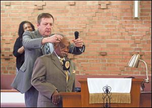 The  Rev. Floyd Rose receives a Valdosta Police Department chaplain's badge from Valdosta Chief of Police Brian Childress.    Mr. Rose is the founder and senior servant at Serenity Christian, ‘The perfect church for imperfect people.’