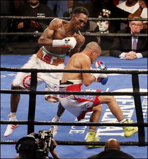 Robert Easter, Jr., left, floors Luis Cruz with a punch during their Feb. 10 boxing match at the Huntington Center. Easter retained his IBF championship belt with the win via decision.