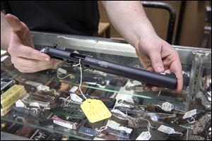 A silencer is displayed at Ed’s Public Safety gun shop in Stockbridge, Ga. For decades, buying a silencer has been as difficult as buying a machine gun. Now, the industry has renewed a push in Congress to ease those restrictions.