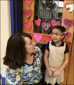 ‘Nurse Cindy’ Muir chats with kindergartner Amazing Peterson at the elementary school.