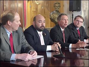 From left, budget Director Tim Keen, House Speaker Cliff Rosenberger (R., Clarksville), Gov. John Kasich, Senate President Larry Obhof (R., Medina) talk about cuts to the proposed next two-year state budget. 