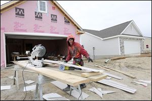 Corey  Proshek cuts siding for a house in the Crystal Ridge subdivision in Monclova Township by McCarthy Builders.  Mr. McCarthy’s firm built nearly 300 homes last year, and he said he anticipates doing at least that many this year.
