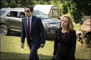 David Duchovny, left, as Fox Mulder and Gillian Anderson as Dana Scully in an episode of 'The X-Files.'