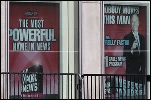Posters featuring Bill O’Reilly were still on display at the News Corp. headquarters in Manhattan on Wednesday shortly after he parted ways with Fox News.