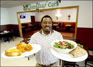 Owner Robert Harris holds two of his vegetarian dishes at Greenleaf Cafe in Toledo: Baked Cheesy Spaghetti and Greenleaf Special Salad.