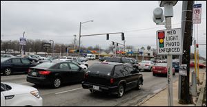 A red light camera is at the intersection of Hill Avenue and Byrne Road in Toledo. A law passed by Ohio lawmakers restricting the use of red light cameras in 2014 is one of several examples of recent home-rule conflicts between the state and its communities.