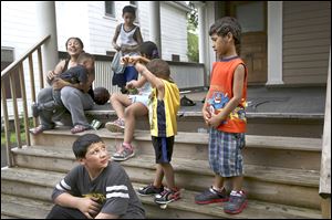 Brian 11, bottom left, watches his brother Joseph, 5, right, as they play with their siblings. Their mother, Yadelis Lopez, back left, says the ordinance has given her more peace of mind as she monitors Joseph’s elevated blood-lead levels.