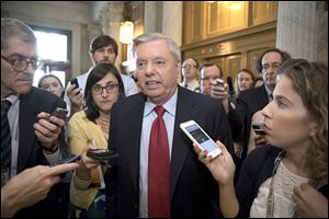 Sen. Lindsey Graham (R., S.C.) is surrounded by reporters as he arrives at the Senate on Capitol Hill in Washington.