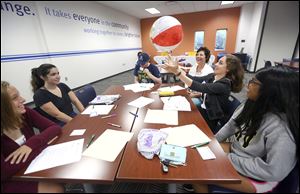 Kenna Edwards, 15, of Southview High School catches a ball and answers some questions about herself as part of an icebreaking exercise during a training session  Thursday for high school students sponsored by the Lucas County Suicide Prevention Coalition at the United Way offices.