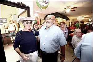 Frank Incorvaia, Jr., co-owner of Inky’s Italian Foods, laughs at Nancy Cryderman, as the two have fun during a 60th anniversary pizza party attended by friends and family.
