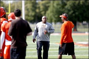 Perry Eliano, center, talks with BG head coach Mike Jinks, right, during a Bowling Green State University football scrimmage at Doyt Perry Stadium in August. Eliano was fired as defensive coordinator of the Falcons on Sunday.