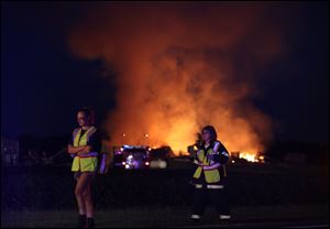 Local firefighters respond as U.S. 20-A is shut down due to a standoff and house explosion in Swanton.